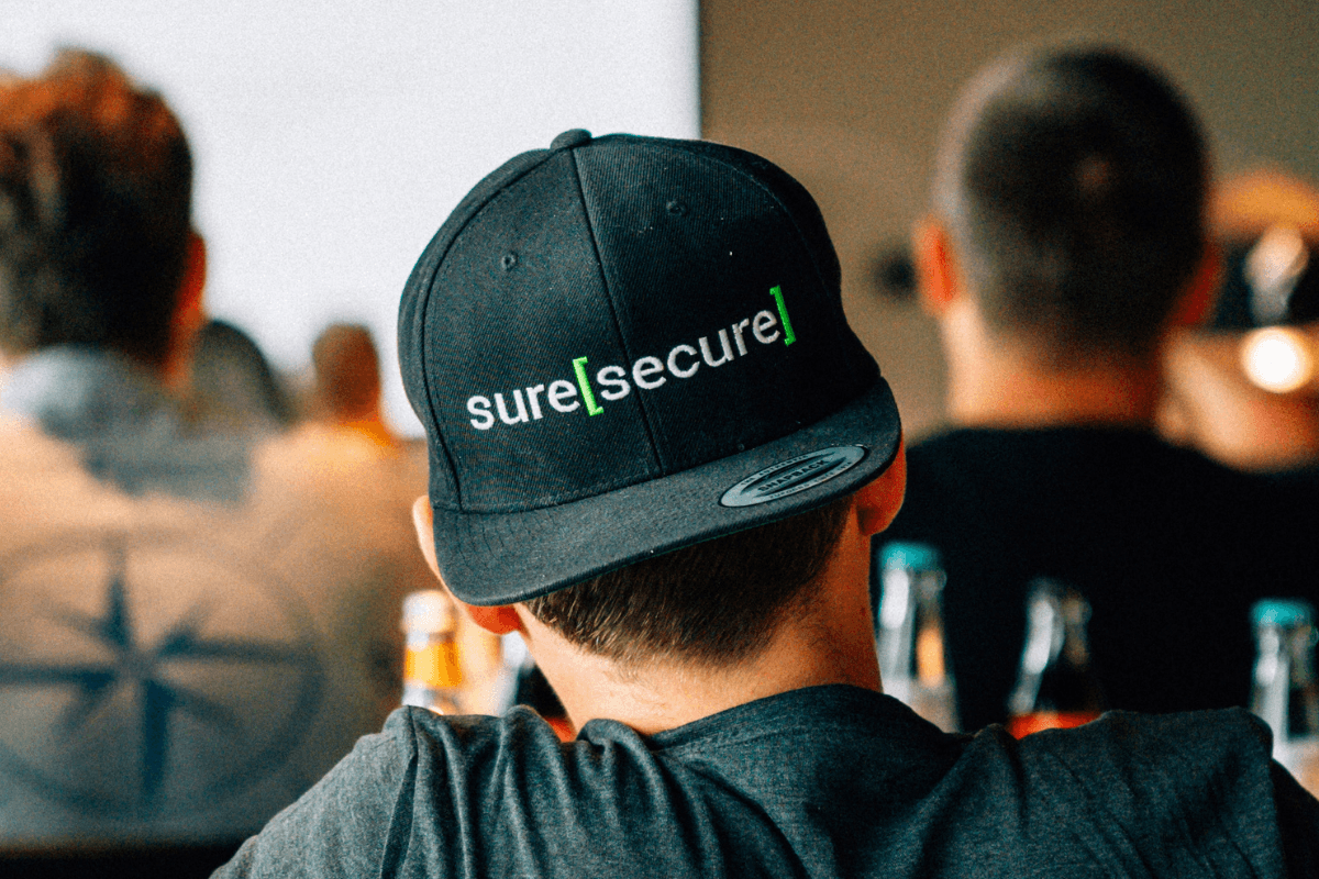 Employee wearing suresecure cap at team event – German IT security company