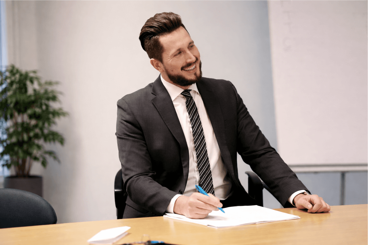A smiling Suresecure employee in the office, carrying out a cyber audit