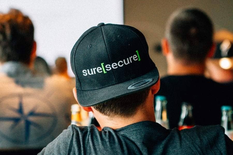 suresecure staff member wearing a cap and sporting the logo, IT security